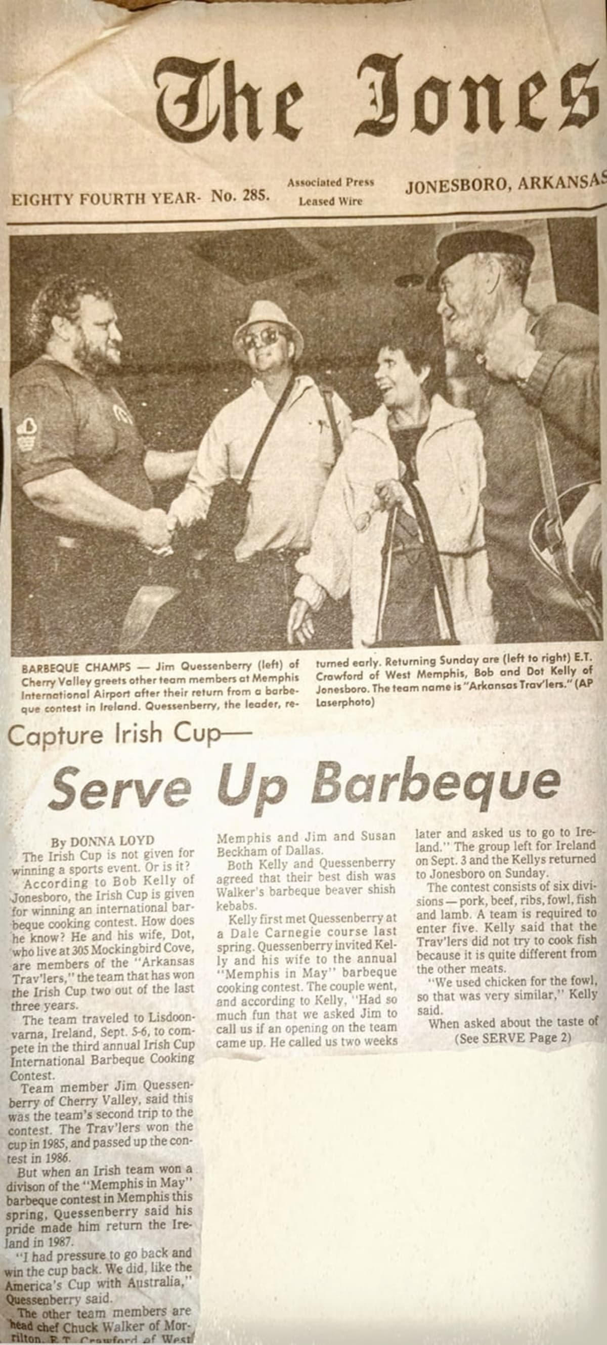 Jim Quessenberry standing with fellow BBQ legends, celebrating his legacy.